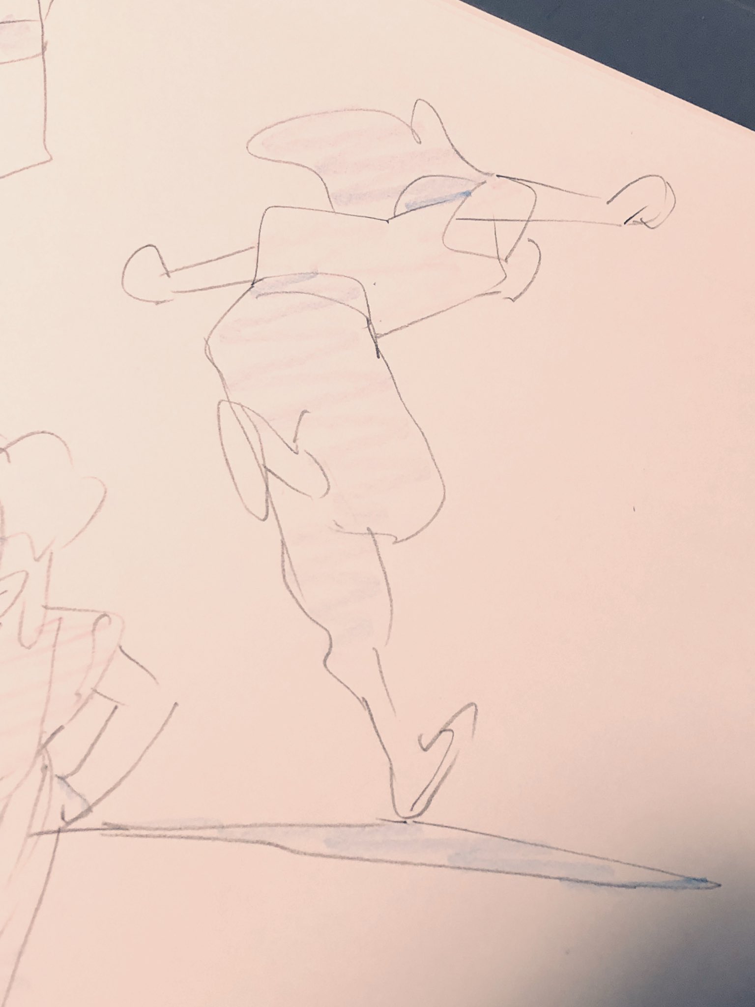 a simple, cartoonstyle drawing of a figure in a dynamic pose, drawn with blue and black pen on white paper. the figure appears to be in midmotion, perhaps dancing or striking a pose. the style is loose and expressive, characteristic of a quick sketch or doodle.  there are some indistinguishable sketches behind the main figure.