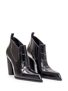 a pair of black leather heeled ankle boots with a pointed toe are shown on a white background.  they are sleek and stylish with a high heel.