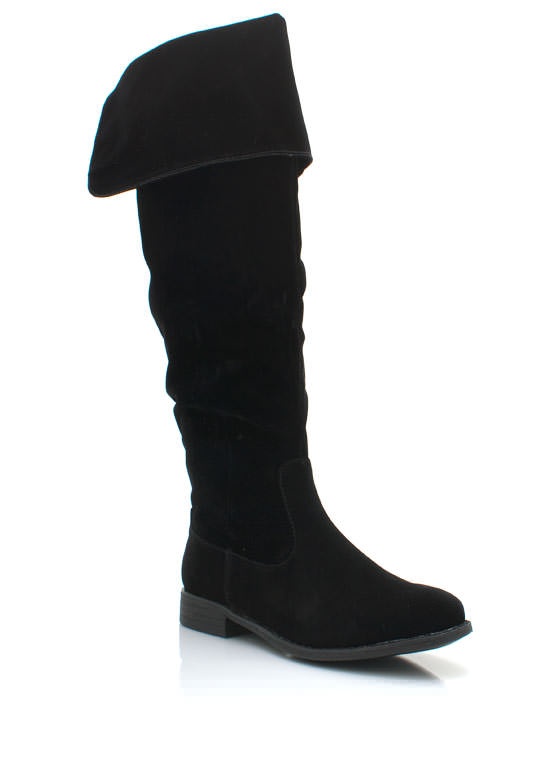 a single black kneehigh boot is shown on a white background. the boot is suedelike and has a slouchy fit around the ankle and a wide, foldedover top. the sole is flat.