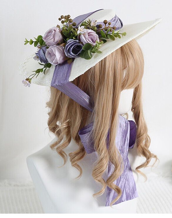 a side view of a woman with long blonde hair, modeling a widebrimmed white straw hat. the hat is adorned with an arrangement of artificial purple and white roses and greenery, and tied with a wide lavender ribbon that trails down the back.