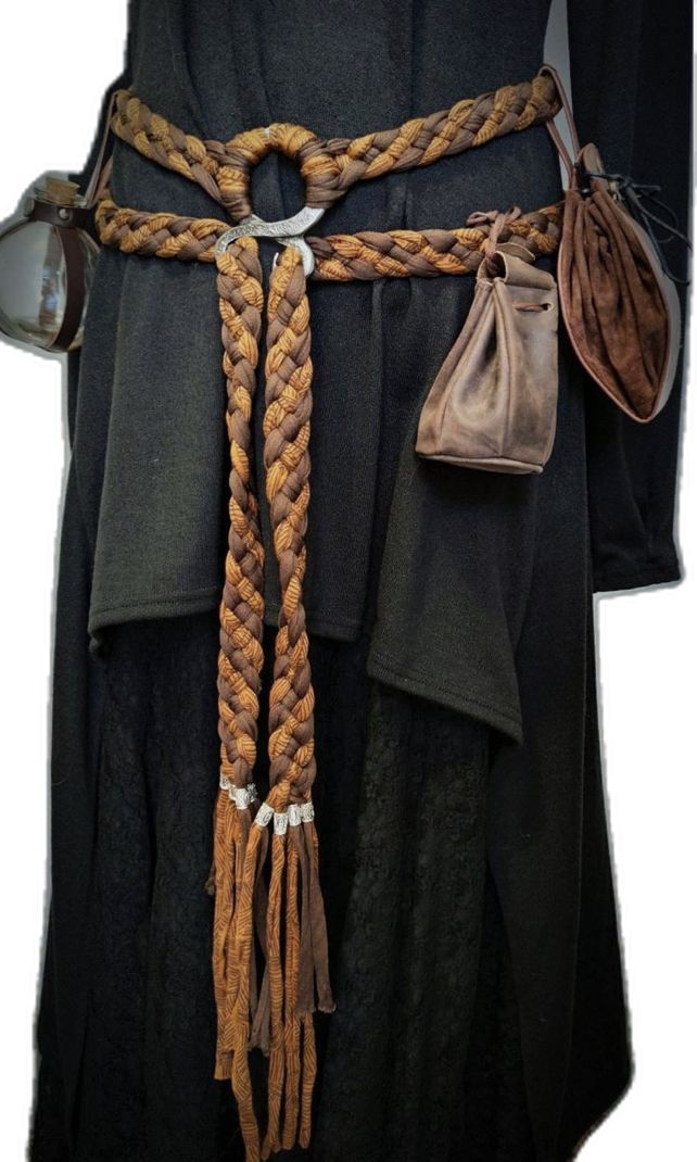 loseup view of a medievalstyle costume. the focus is on a intricately braided brown leather belt with tassels.  the belt is worn over a long, darkcolored robe.  two small leather pouches are attached to the belt.  the overall style suggests a fantasy or historical setting.