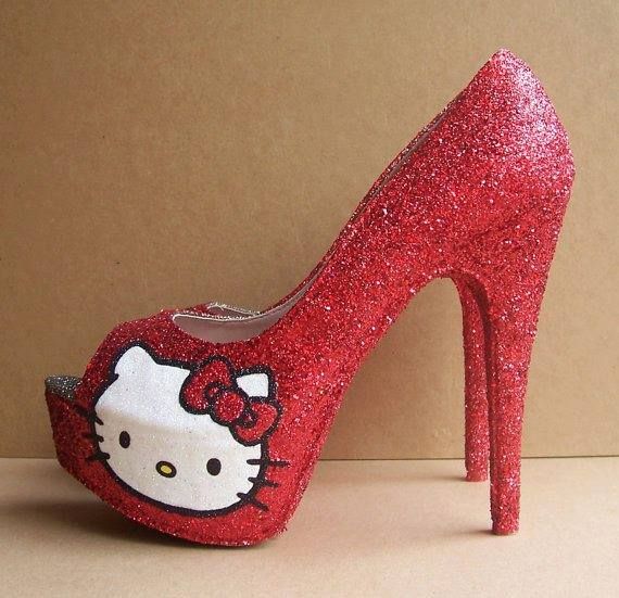 a red glitter high heel platform shoe with a hello kitty face on the toe.