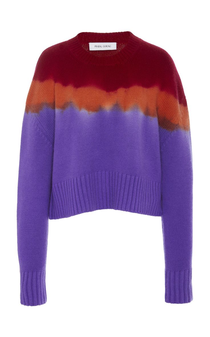 a purple, red, and orange tiedye long sleeve crew neck sweater for women. it's a casual sweater for women, made of knit material.  the sweater has a casual look. it has a crew neck and long sleeves. it's a tiedye pattern and has a purple, red, and orange color combination.  the sweater is a good choice for everyday wear.