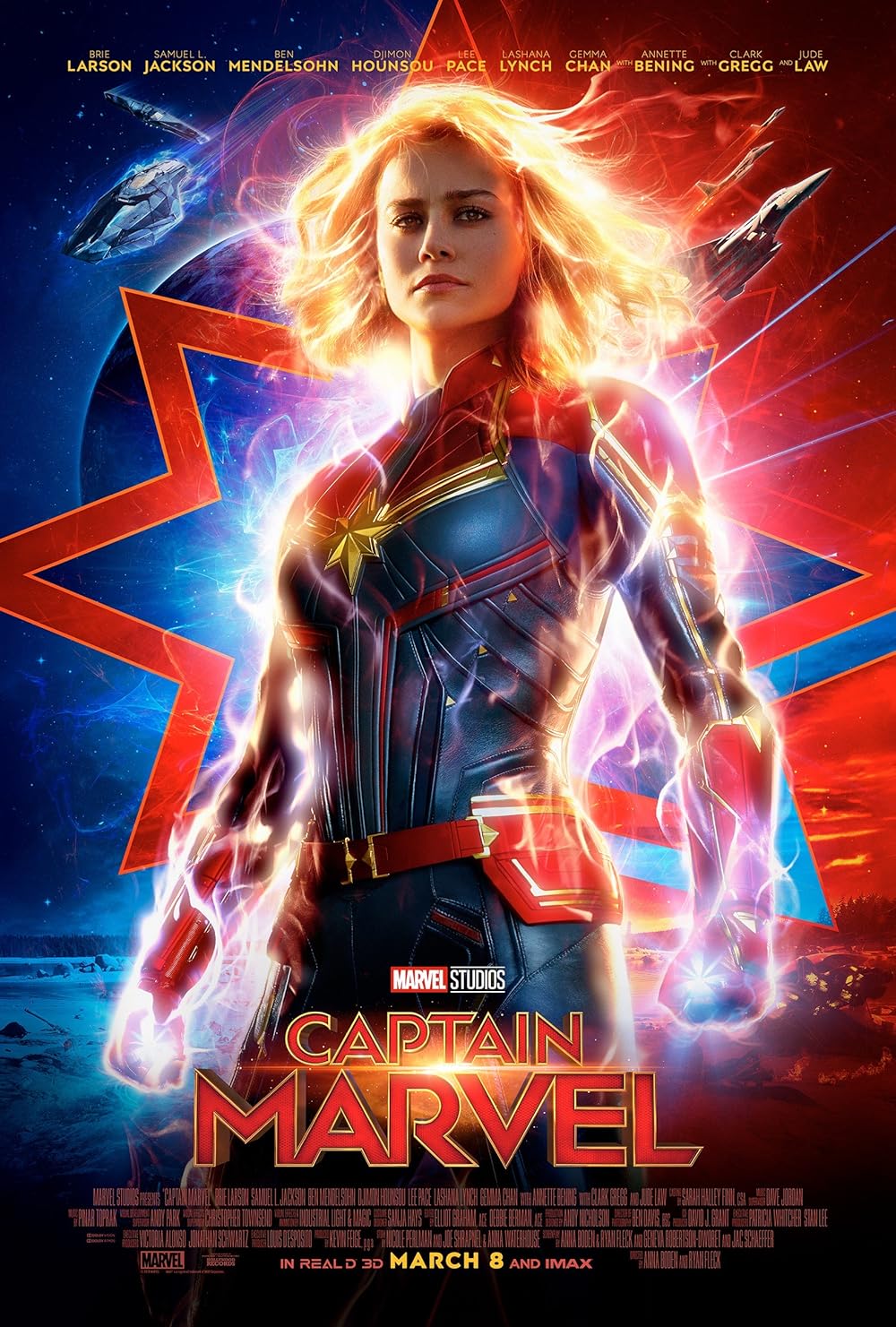 this is a movie poster for the 2019 marvel studios film captain marvel.  the poster features brie larson as carol danvers/captain marvel in her iconic suit, glowing with energy. the background is a vibrant mix of red and blue, depicting a starburst effect and glimpses of spaceships.  the title "captain marvel" is prominently displayed, along with the release date and supporting cast names.  the overall style is dynamic and actionpacked, conveying the power and excitement of the film.