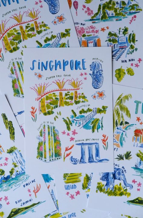 a stack of postcards featuring illustrations of various cities in asia.  the top postcard features a singapore illustration that depicts the super tree grove, gardens by the bay, marina bay sands, and sentosa, all marked with their corresponding names. other postcards feature illustrations of hoi an, ha noi, koh samui, and ubud. the postcards all feature handdrawn illustrations in a bright and colorful style.