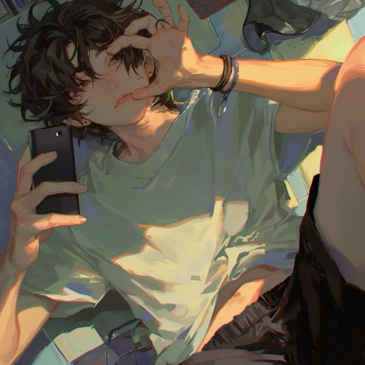 the image is of an anime boy sitting with one leg crossed over the other, casually looking at his phone with one hand holding it and the other resting on his leg. he's wearing a green tshirt with a black shortsleeved shirt under it, black pants, and what appears to be a black belt. he's also wearing a black bracelet and has a black earring in one ear. he is smiling and looking at the camera, while holding a phone in his other hand.