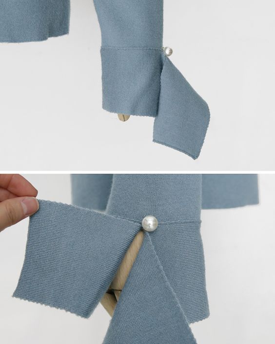 two closeup images of a blue knit sleeve with a pearl button and a split cuff detail. the first image shows the sleeve and cuff extended, with the pearl button visible. the second image shows a hand pulling back one side of the split cuff to reveal the mannequin arm underneath.