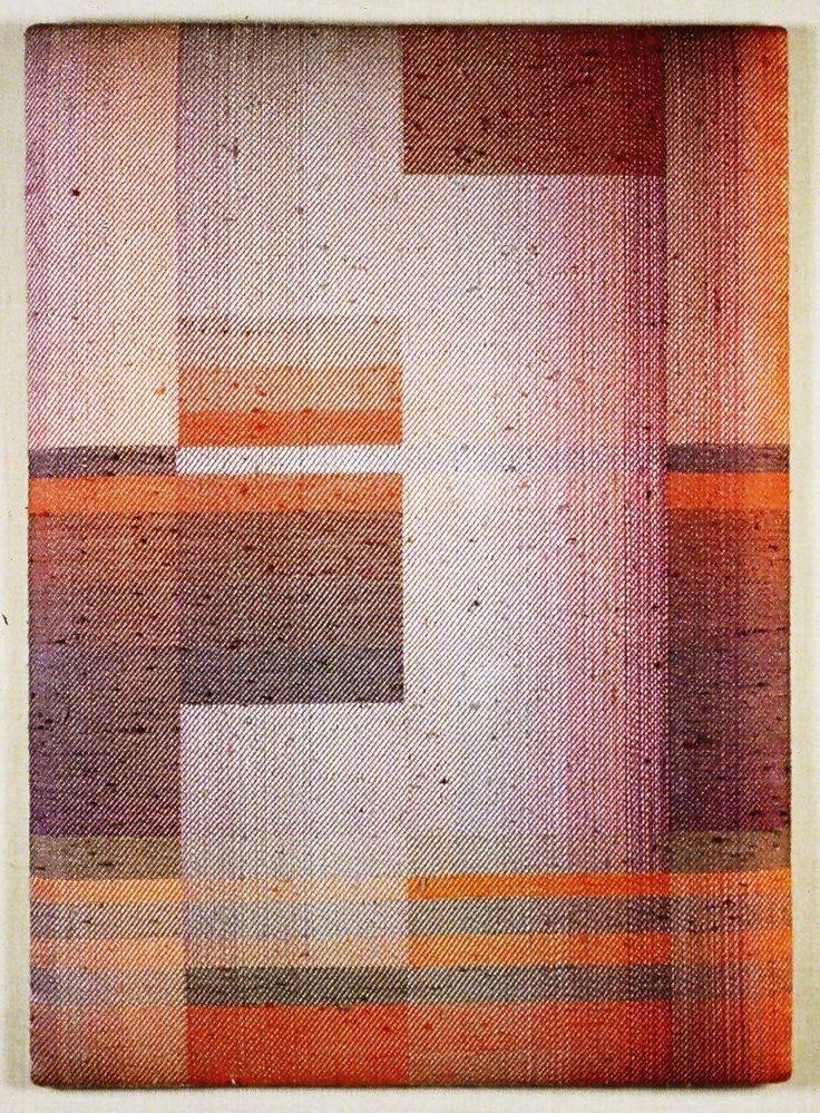 the image shows a closeup view of an abstract woven tapestry. the tapestry features a geometric pattern of squares and stripes in shades of orange, brown, red, grey and white. the weave creates a textured surface with distinct horizontal lines. the piece is abstract in its lack of recognizable forms and is created through the manipulation of the weave and colors. it likely comes from the mid20th century when weaving and fiber arts were especially popular.