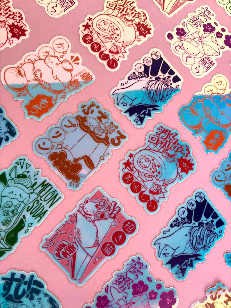 the image shows a collection of numerous colorful, kawaiistyle stickers featuring various japanese sweets and desserts.  the stickers are arranged on a pink background, and each showcases a unique illustration of items like mochi, melon soda, a cat enjoying a crepe, and a whaleshaped dessert. the designs incorporate japanese text and pastel color schemes, creating a playful and aesthetically pleasing collection.  the stickers appear to be made from a slightly translucent material. the overall style is reminiscent of anime and japanese pop culture aesthetics.