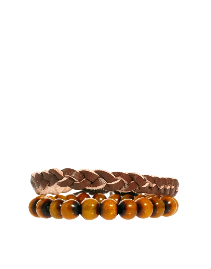 a braided brown leather bracelet layered on top of a wooden bead bracelet. both bracelets are shown on a white background.