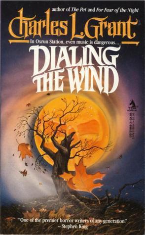 this is a book cover for charles l. grant's novel "dialing the wind." the cover features a stylized illustration of a bare tree silhouetted against a large, orange moon.  falling leaves are scattered around the tree, and the overall mood is dark and atmospheric, suggesting a horror or gothic theme.  the title is prominently displayed, along with the author's name and a quote from stephen king praising grant's writing. the cover's style suggests it's from the 1980s.