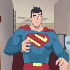 an image of superman from an animated film or series. superman appears surprised or concerned as he looks towards something offscreen to the right. he is in a hallway with light blue walls and white trim.  the animation style is contemporary and somewhat simplified.