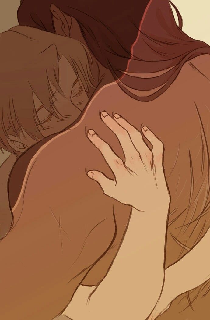 a woman with brown hair is hugging a woman with blonde hair from behind. they are holding each other tightly, with the