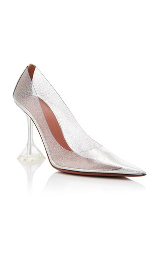 a pair of silver sparkly transparent high heel pumps with pointy toes. the shoes have a clear heel and are set on a white background.