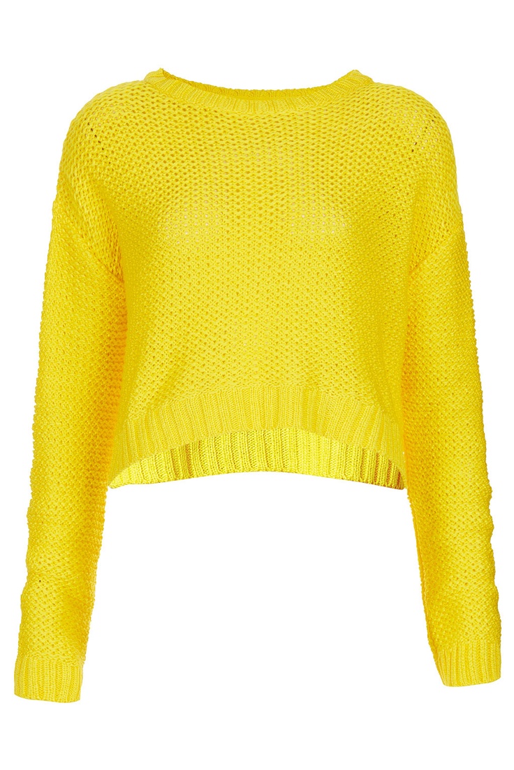 a bright yellow, cropped knit sweater with long sleeves. the sweater has a casual, relaxed fit.  the sweater has a subtle textured knit pattern, and the sleeves are long and slightly gathered at the cuffs. the sweater is a versatile piece that can be dressed up or down.