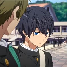 two anime characters, likely high school boys, stand on a bridge outside a school building. the focus is on the boy on the right, who has dark blue hair and blue eyes. he is wearing a black and white school uniform with a white bag strap over his shoulder. the boy on the left, partially out of frame, has brown hair and is wearing a similar uniform with a green bag. the background suggests a bright sunny day. the art style is characteristic of anime, with detailed features and vibrant colors.