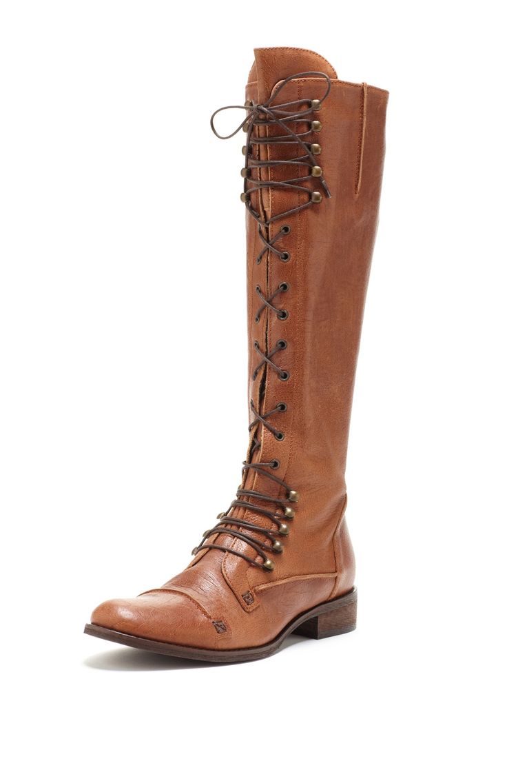 a single brown leather women's tall boot is displayed on a white background. the boot is laced up the side with dark brown laces and small brass eyelets.  the boot has a slightly pointed toe and a low, block heel. the leather appears soft and supple. the overall style is casual, yet stylish, suggesting a bohemian or vintage aesthetic.