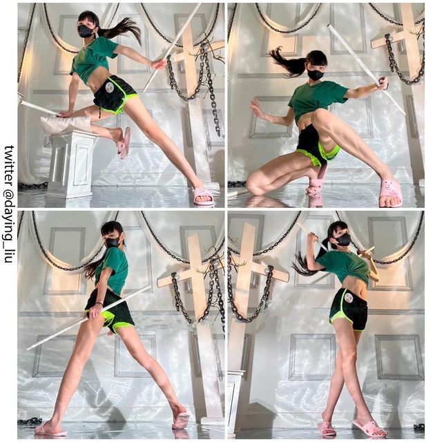 the image is a collage of four photos showcasing a young woman in various dynamic action poses. she's wearing a green crop top, black athletic shorts with neon green accents, pink slides, and a black face mask.  she's wielding a long staff or stick in each pose, demonstrating different fighting stances or martial arts movements. the background features a minimalist, almost gothic aesthetic with white walls, ornate crosses adorned with chains.  the overall impression is one of strength, agility, and stylized action. the photos are credited to "twitter @daying_liu."