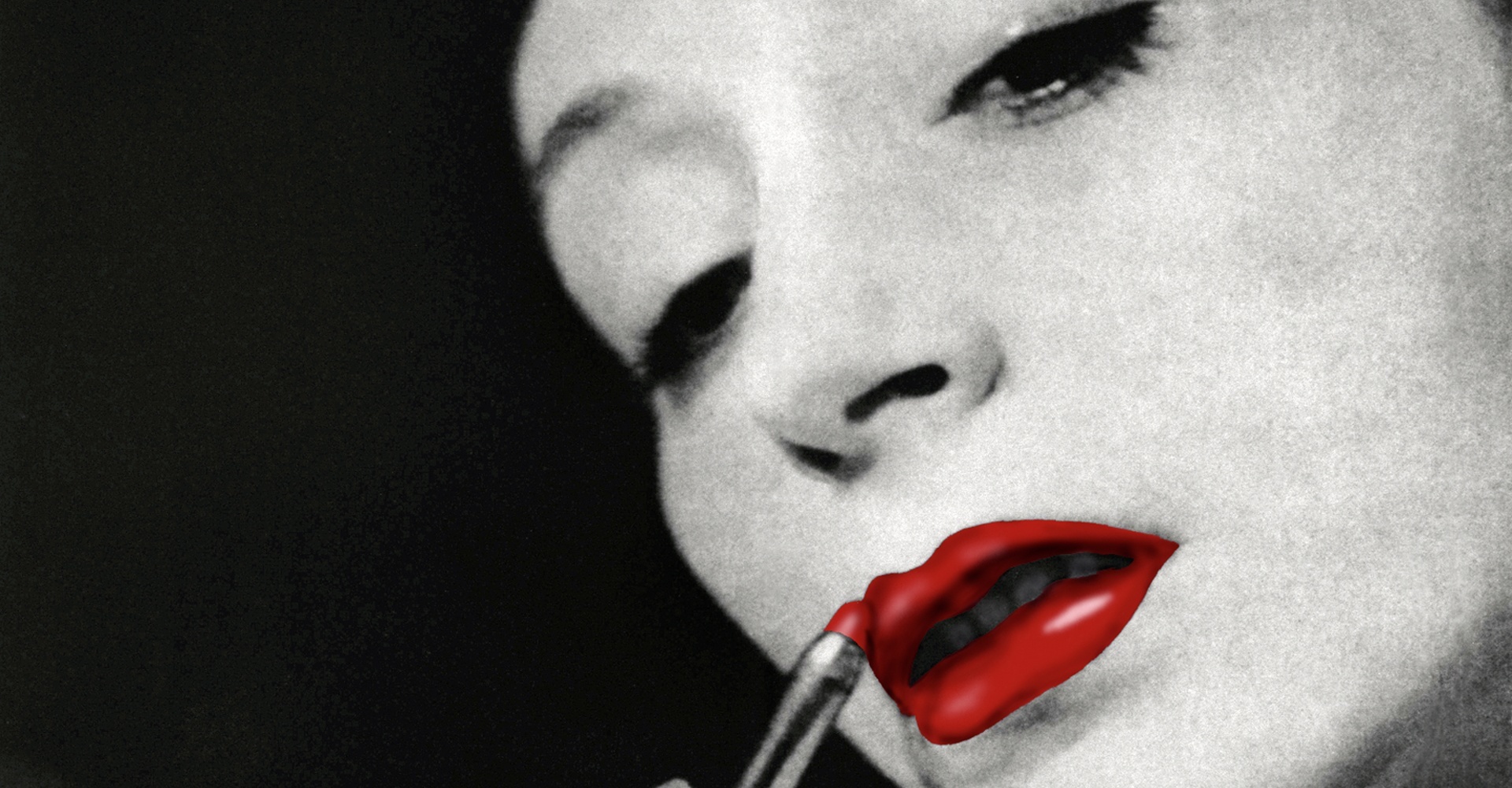 the image is a closeup, black and white portrait of a woman applying red lipstick. the photograph is styled with a grainy texture, giving it a vintage or retro feel reminiscent of classic hollywood glamour photography.  only her face and upper shoulders are visible. her expression is one of subtle seduction or contemplation. the stark contrast between the black and white tones of her face and the vibrant red of her lipstick draws the viewer's attention to her lips. the lipstick application is in progress, and the lipstick tube is visible.