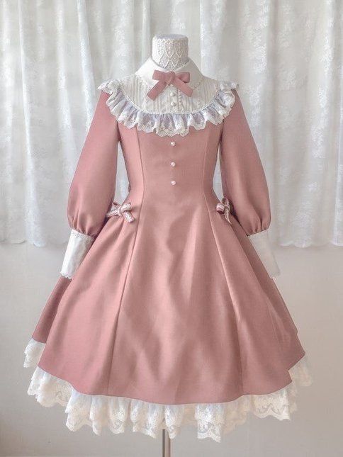 the image showcases a fulllength view of a pink lolita fashion dress displayed on a mannequin. the dress, in a soft, dusky pink hue, features a classic silhouette with a fitted bodice, long sleeves, and a full, flowing skirt.  the bodice is adorned with delicate white lace detailing around the collar and along the neckline, creating a romantic and feminine touch. a bow at the neck adds a sweet and charming detail. the skirt falls gracefully from the waist, cascading down to the floor in a cascade of soft folds. a white lace trim adorns the hem of the skirt, adding a touch of elegance and sophistication. the dress is perfect for special occasions or for those who appreciate a touch of vintageinspired fashion.