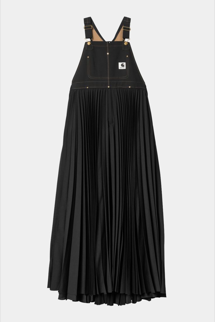a black carhartt dress with a pleated skirt. the top of the dress is designed like overalls, with straps and a bib.