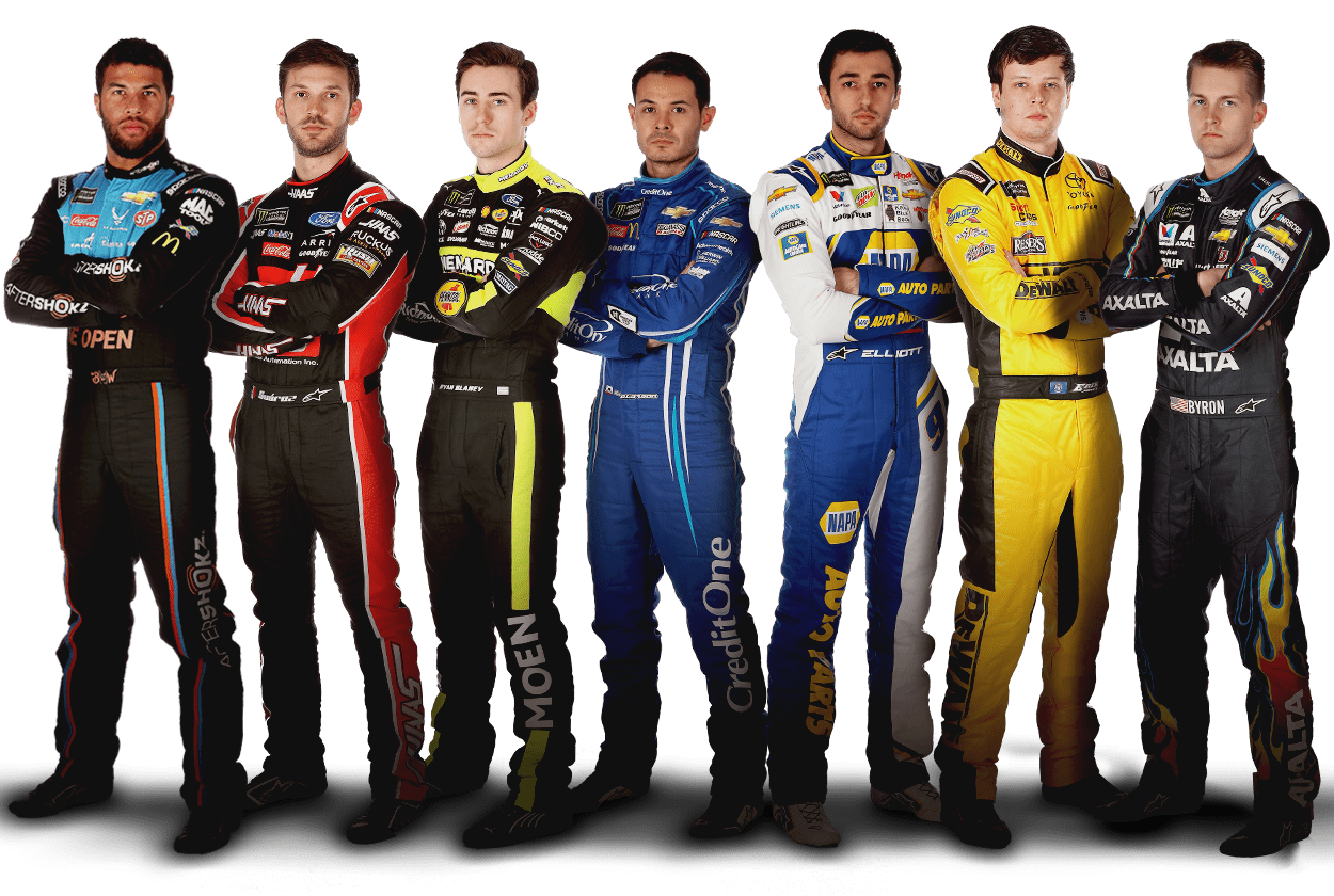seven nascar cup series drivers, all sponsored by chevrolet, ford or toyota, stand in a line with their arms crossed, each wearing their racing suit.