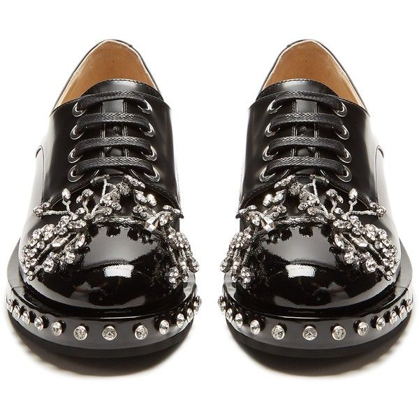 a pair of black patent leather oxford shoes with crystal embellishments and studded detailing. the shoes are laceup and have a slightly chunky sole. they are shown from a slightly elevated angle. the image is clean and welllit, showcasing the details of the shoes.