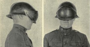 two men in military uniforms are wearing helmets that are covered in a meshlike material that covers their faces. the image appears to be from the early 20th century.