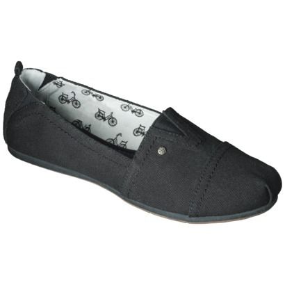 a closeup shot of a black canvas slipon shoe with a flat sole and bicycle print lining.