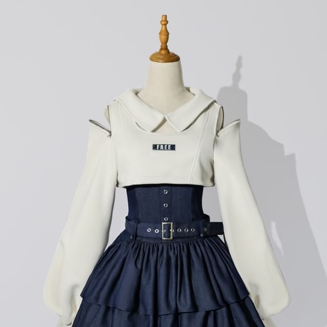 a white offtheshoulder top with long sleeves is paired with a blue denim skirt. the top has a peter pan collar and a small "free" label on the front. the skirt is tiered and has a wide belt. the outfit is modeled on a mannequin.