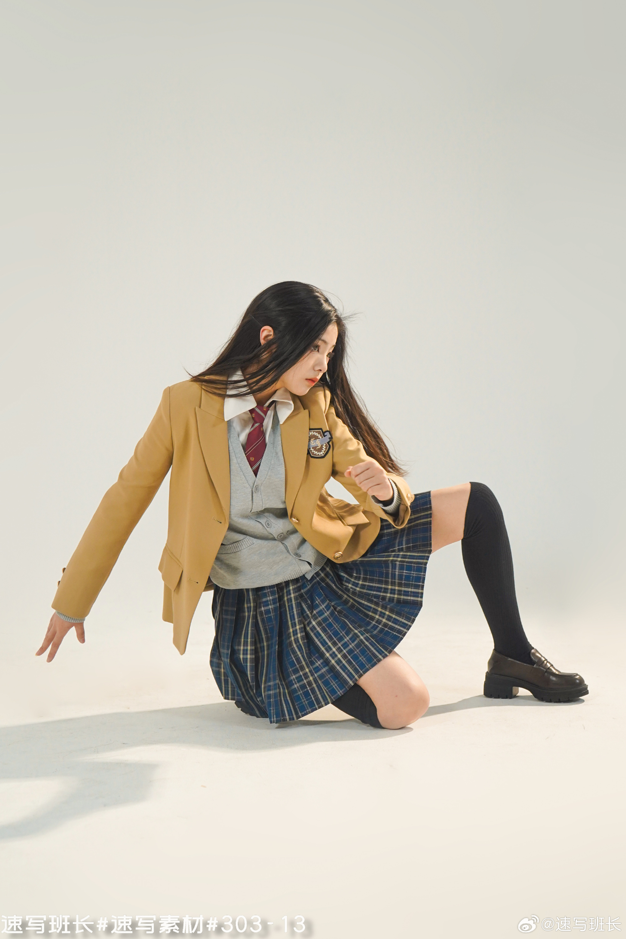 a young woman wearing a school uniform is posing on a white studio background. she is wearing a beige blazer, a grey cardigan, a blue and green plaid skirt, black socks, and black shoes. she has long black hair and is looking off to the side. her pose is dynamic and suggests a sense of movement. the lighting is soft and natural, highlighting the details of her outfit and her graceful pose.