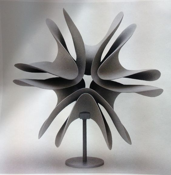 the image showcases a gray abstract sculpture reminiscent of a stylized flower or starburst. it features multiple curved, petallike forms emanating from a central point and resting on a pedestal. the sculpture is set against a muted gray background, emphasizing its form and creating a sense of elegance and simplicity. the soft lighting enhances the sculpture's curves and adds to its threedimensionality.