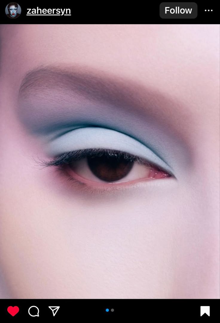 a closeup image of a person's eye with blue eyeshadow and pale skin. the eyebrow is lightcolored and the eyelashes are dark. the eye is brown. the overall aesthetic is clean and focused on beauty.