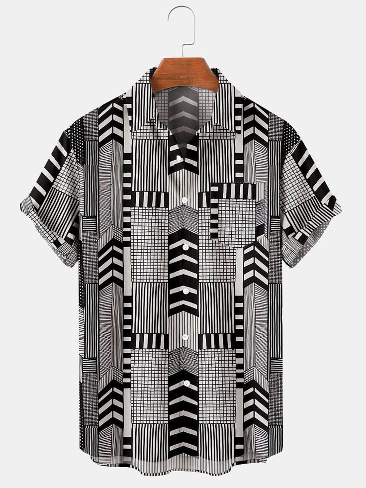 a black and white shortsleeved buttondown shirt with a geometric pattern hanging on a hanger.