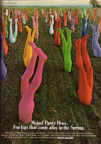 an advertisement for mojud panty hose featuring multiple pairs of colorful pantyhose seemingly planted in the ground like crops, creating a surreal and whimsical visual. the text promotes the variety of colors and the comfortable stretch of the pantyhose, tying it to the theme of legs "coming alive" in the spring.