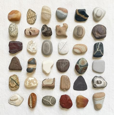 a collection of 36 rocks, stones, pebbles, and mineral samples, all laid out in a grid pattern. they vary in size, shape, texture, color, and pattern. the rocks are all arranged in a neat and organized way, and their colors are mainly earth tones, such as brown, beige, grey, black, and red. they appear smooth and natural, showcasing the unique beauty of rocks and their patterns.