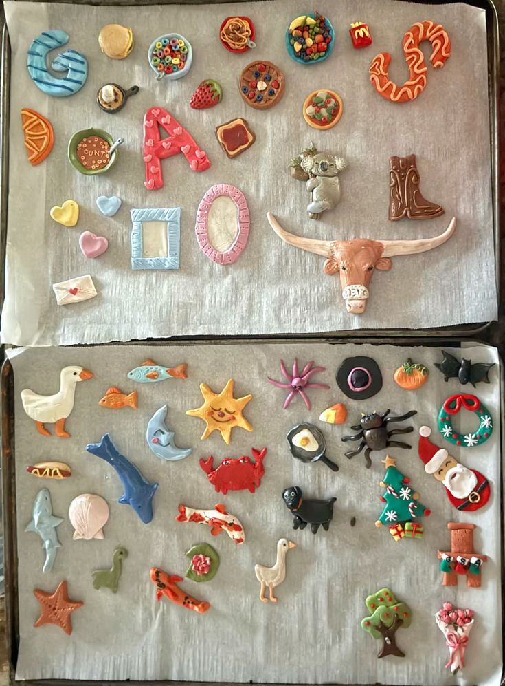 the image shows two baking sheets filled with clay sculptures. the sculptures include various food items like cereal, pancakes, pizza, fruits, and toast, as well as animals such as a goose, fish, sun, crab, dog, koala, and a bull. there are also seasonal themed sculptures such as christmas tree, santa, bats, pumpkin. various letters, frames, and hearts can be found.