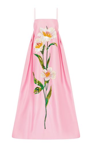 a pink spaghetti strap dress with a floral print design.