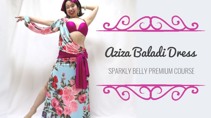 a woman is posing in a colorful floral dress, with a pink bra visible. the dress is described as an "aziza baladi dress" from a "sparkly belly premium course". she is smiling and appears to be performing a belly dance move. the image is likely advertising an online dance class or course.