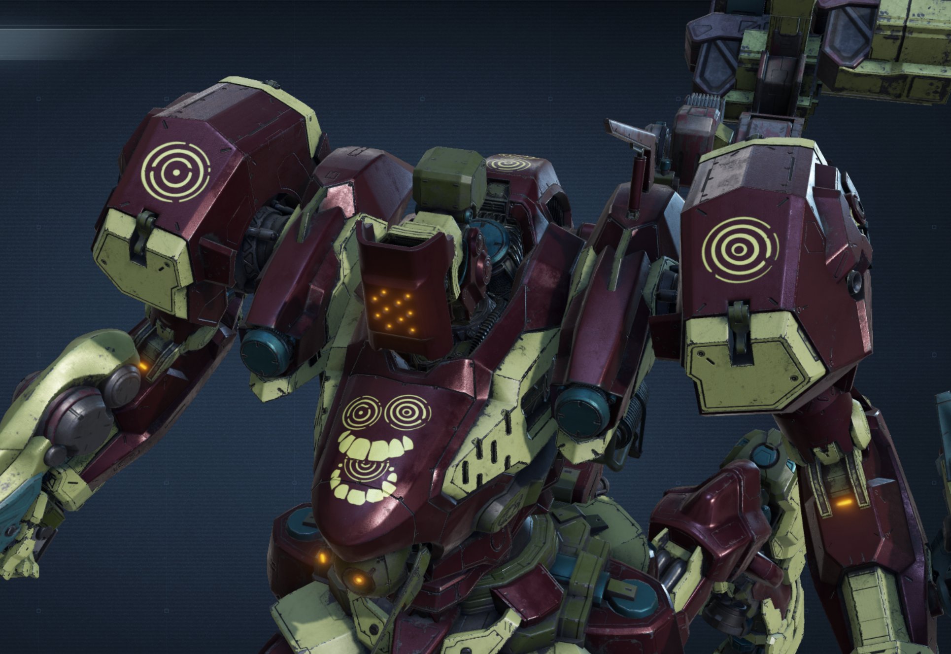 a 3d model of a humanoid robot set against a dark blue background. the robot has a red and yellow color scheme and features intricate armor detailing. its faceplate displays a stylized yellow smiley face. the image appears to be a render from a video game.