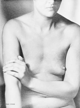 a black and white closeup photograph of a nude woman's torso. her arms are crossed over her chest. the lighting is soft and diffused, creating subtle shadows and highlighting the texture of her skin. the overall tone is intimate and somewhat clinical, suggestive of both artistic and possibly medical or anatomical intent. the image focuses on the natural form of the female body. the graininess of the photograph suggests it might be an older image.