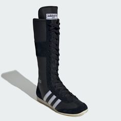 a pair of black adidas boxing boots with white stripes.