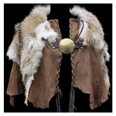 a brown medieval or renaissanceera cape with fur trim at the shoulders, held together by a leather strap and a large round fastener in the center.