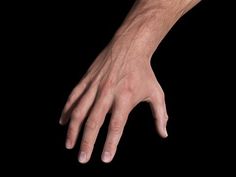 the image shows a closeup of a man's hand and forearm against a black background. the hand is extended with the fingers slightly curled. the soft lighting emphasizes the texture of the skin and the details of the hand.