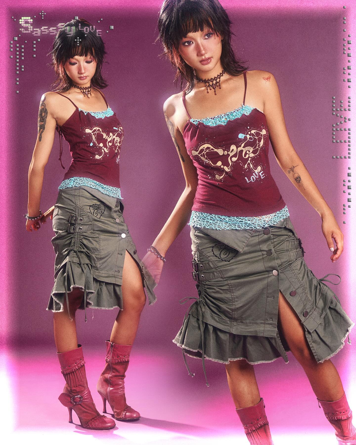 the image showcases two identical young women, styled identically, against a vibrant pink background. they are wearing matching outfits:  a burgundy tank top adorned with light blue lace trim and embroidered details,  a layered olivegreen ruffle skirt with a side slit and drawstring accents, and high pink boots. both models have similar short dark hair and wear delicate chokers. the overall aesthetic is reminiscent of early 2000s or y2k fashion, with grunge and edgy elements. the image has a stylized, almost digital, look with a slight grain or filter effect. one model is positioned slightly ahead of the other, creating a dynamic, duplicated pose.