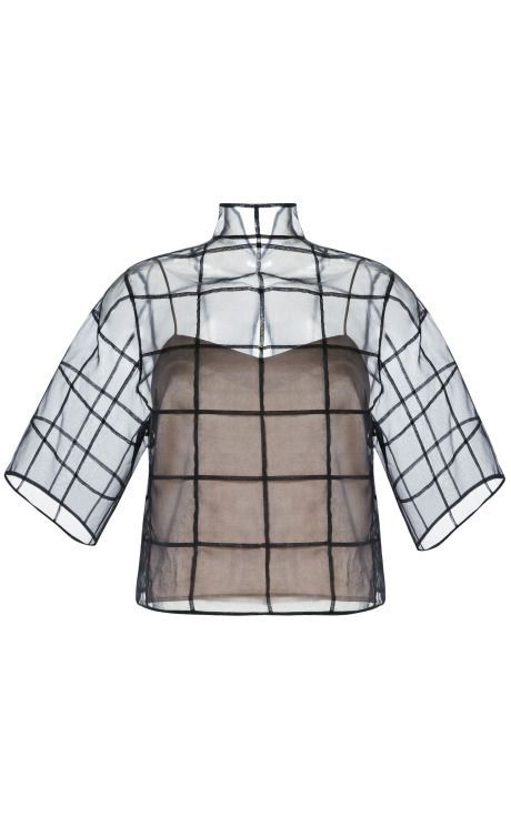 a semitransparent blouse with a grid pattern and quarter sleeves, featuring a turtleneck design. a nude tank is underneath the blouse.
