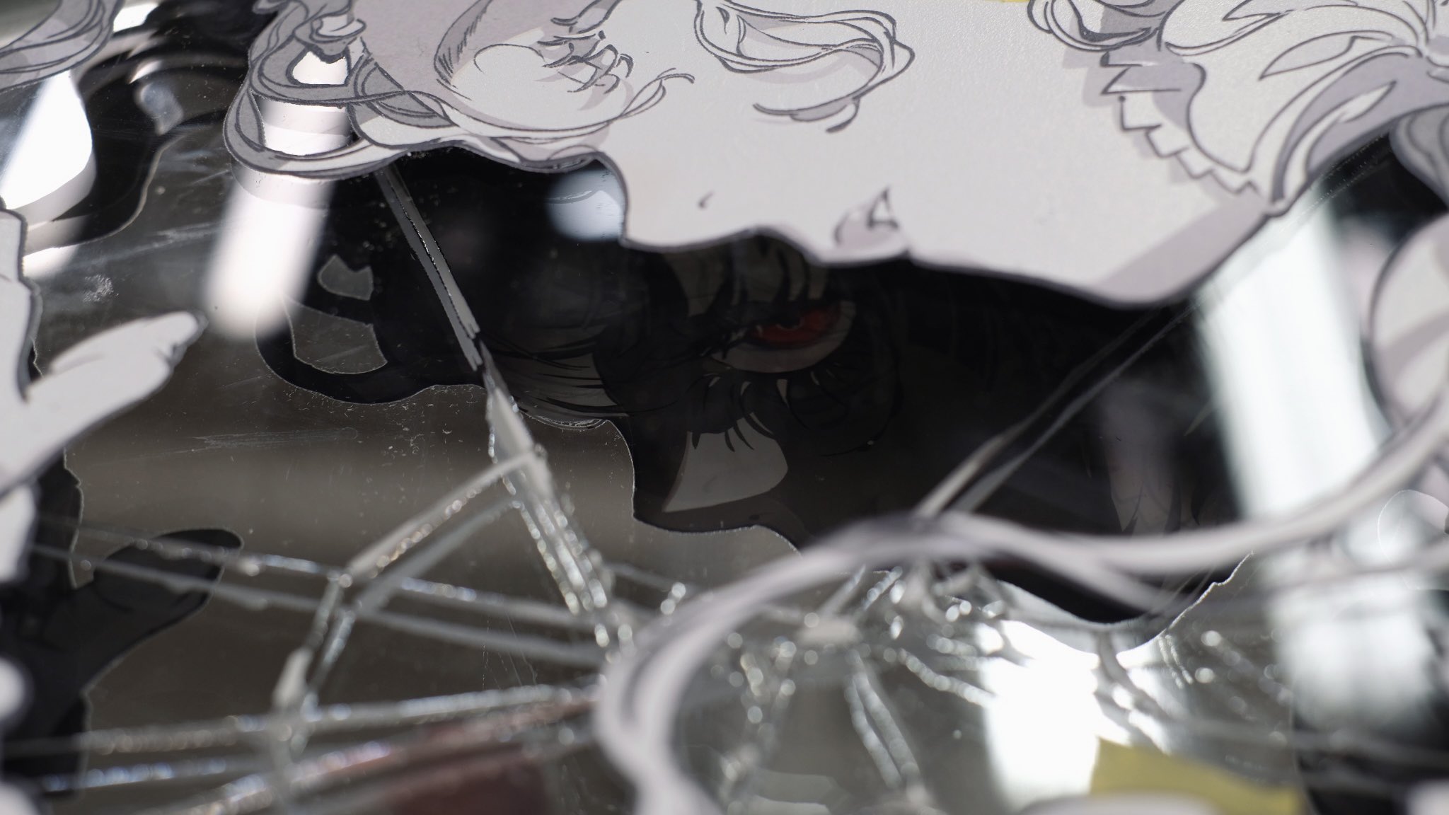 this image features a captivating interplay of animeinspired illustrations and a shattered mirror.  atop the fragmented surface lie black and white illustrations of a girl with flowing hair, their features partially obscured. a striking contrast is introduced with a vibrant red eye peering out from beneath the broken glass, adding a sense of depth and intrigue to the composition. the reflection of the artwork in the shattered pieces adds a layer of distortion, further emphasizing the fragmented nature of the image. the interplay of light and shadow across the broken surface enhances the textures and creates a captivating visual experience.