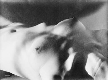 the image is a black and white photograph of a female torso. the focus is soft and blurry, creating an abstract and dreamlike effect.  the lighting is dramatic, with strong shadows and highlights that emphasize the curves and texture of the skin. the overall mood is sensual and intimate.  the lack of sharp focus obscures fine details, focusing instead on the overall form and shape of the body.  the image's style suggests artistic intent rather than a purely representational depiction of the body.