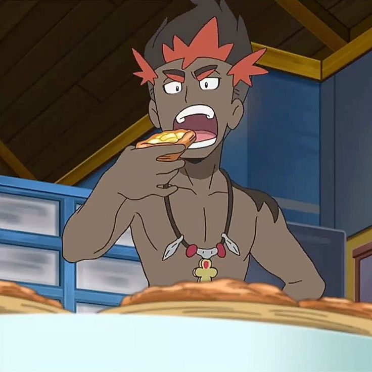 a cartoon man with red hair and a necklace is shown eating a slice of pizza with his mouth open. he is standing in front of a blue and yellow counter.  the background is a blurred image of a kitchen.