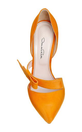 a pair of orange high heels with a suede finish and a bow detail. the shoes are pointytoed and have a high stiletto heel.  the shoe brand "d'orsay" is written on the inside.  the heels are a summery color.
